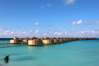 jetty view to the water villas at six senses, laamu, maldives