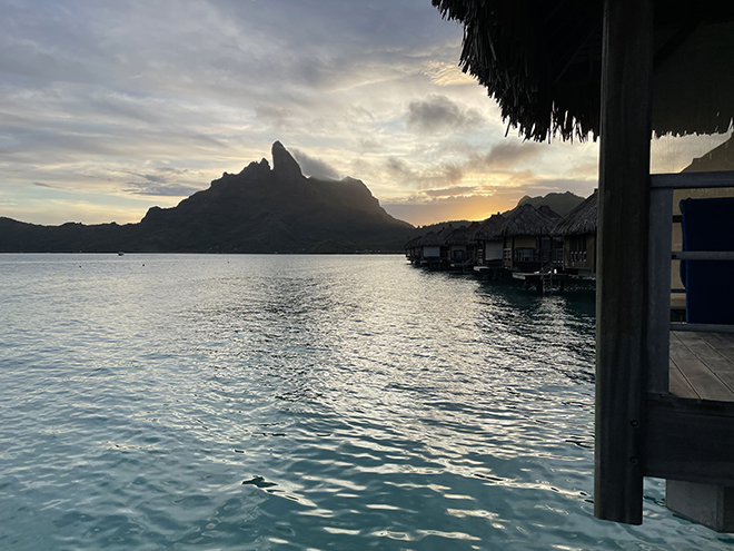 The view of a sunset from an overwater bungalow in St Regis, Bora Bora.