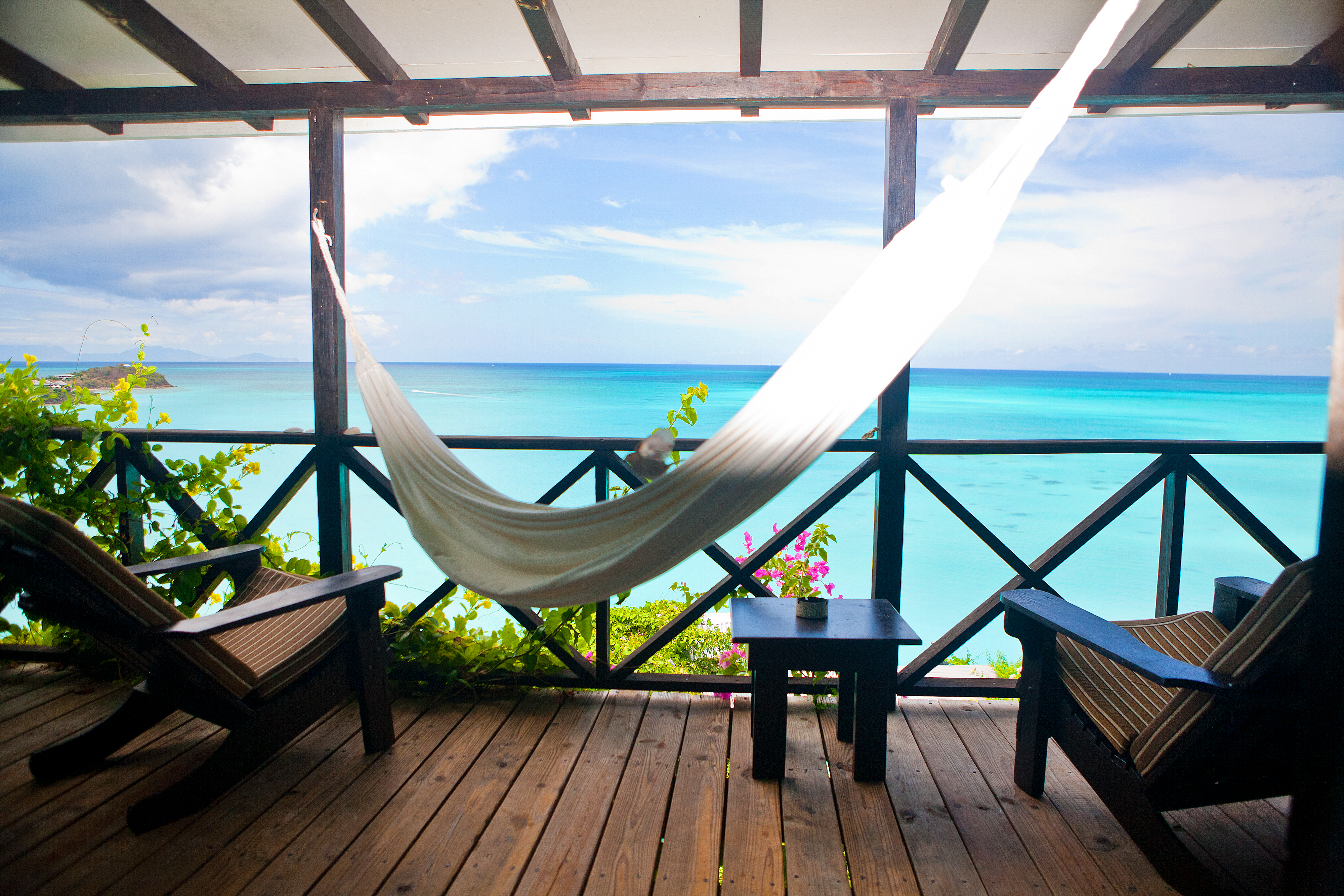 Balcony view from COCOS with an inviting hammock overlooking the sea