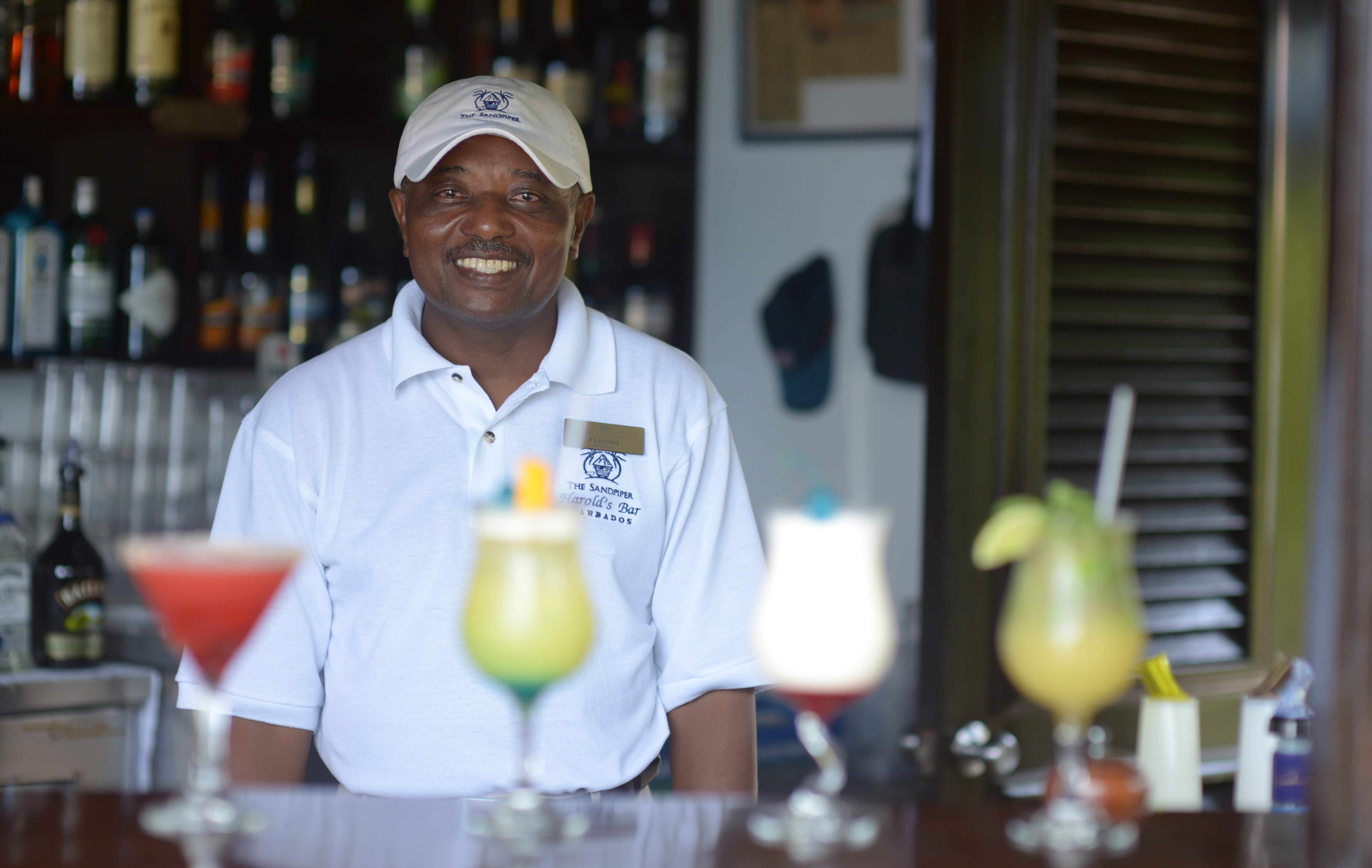 Harold serving exotic drinks at The Sand Piper