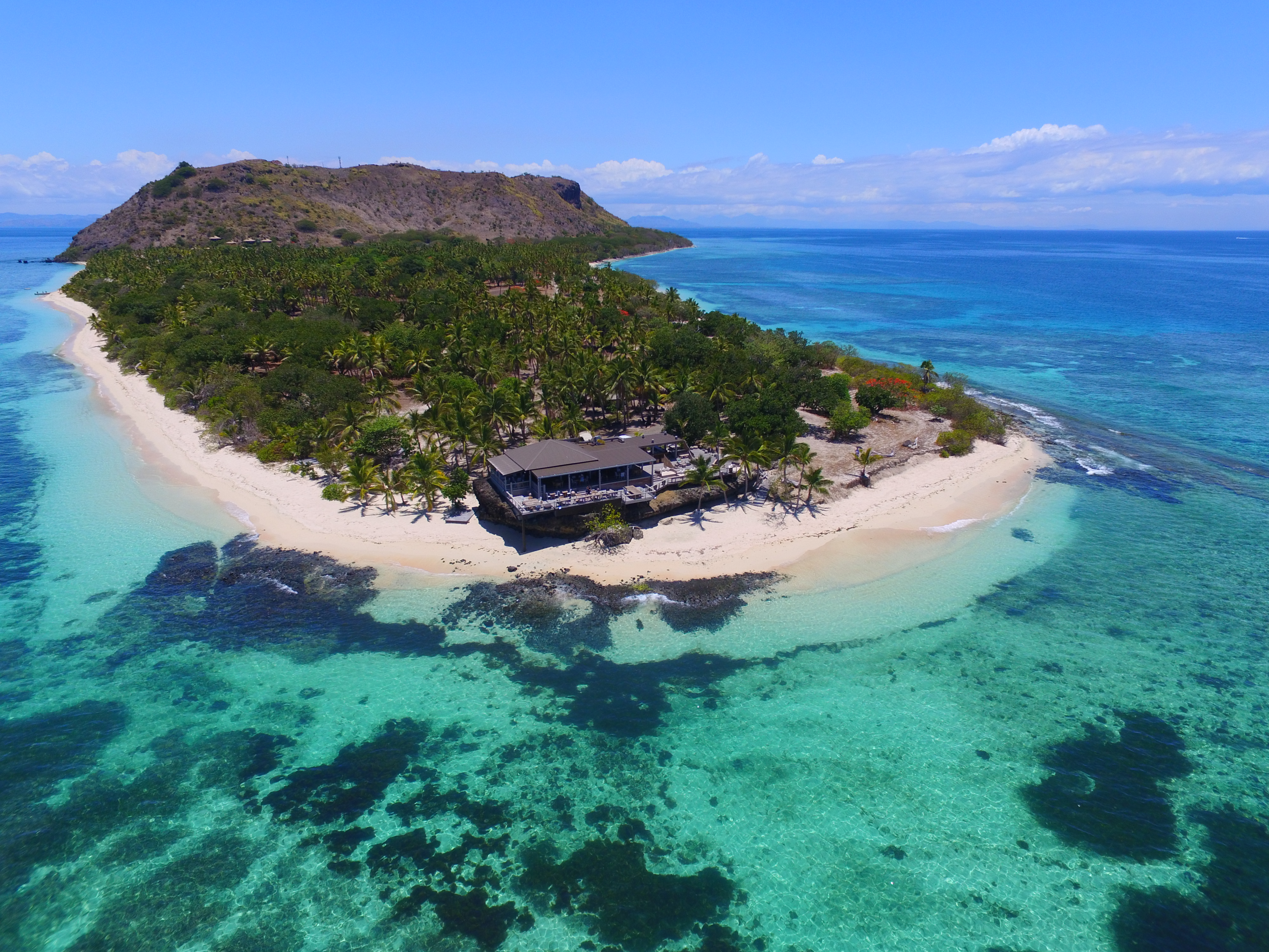 Aerial view of Vomo Island Resort surrounded by crystal clear waters