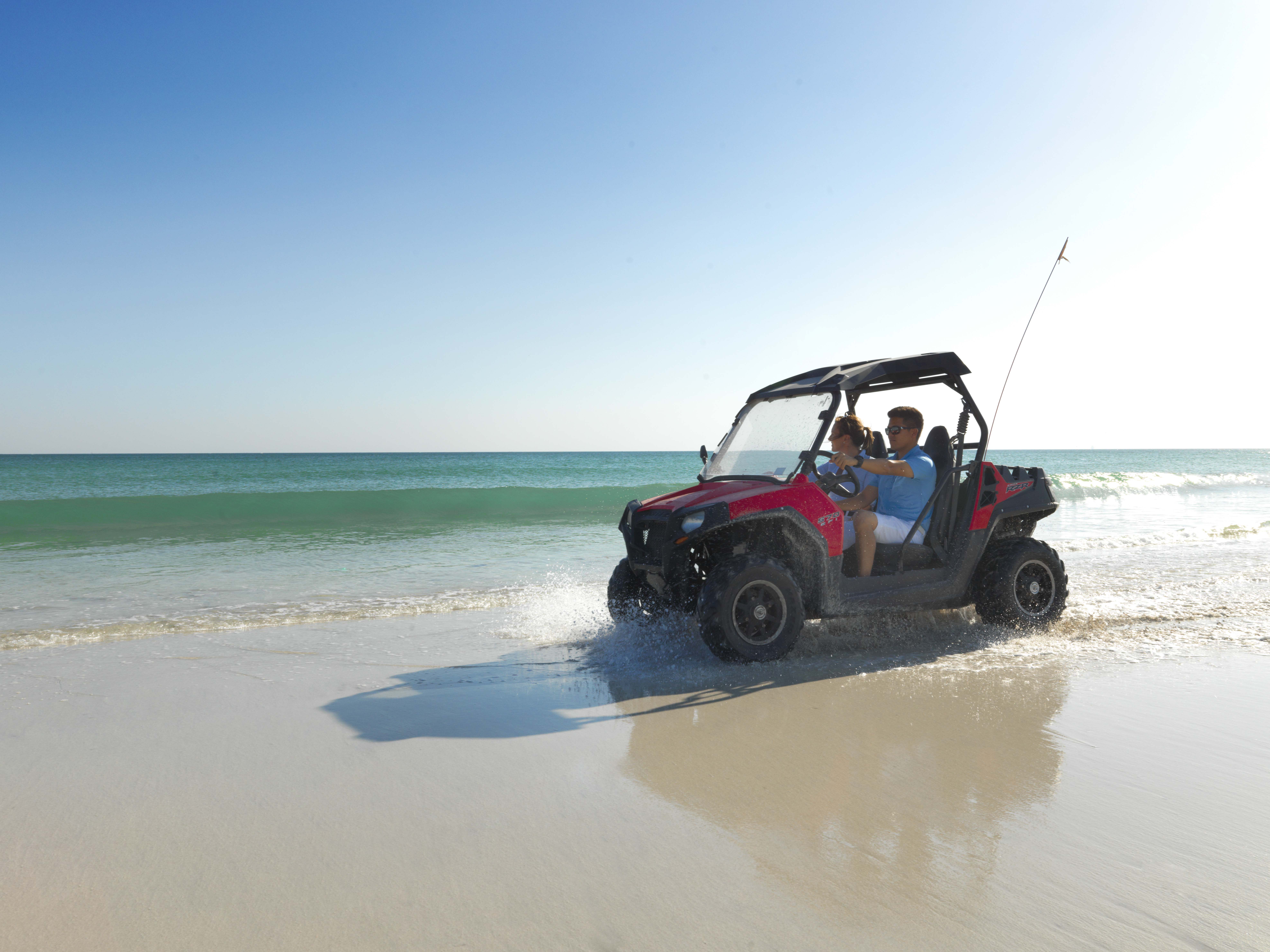 Children enjoy an exhilarating beach buggy ride next to the sea at Al Baleed Resort Salalah by Anantara, Oman