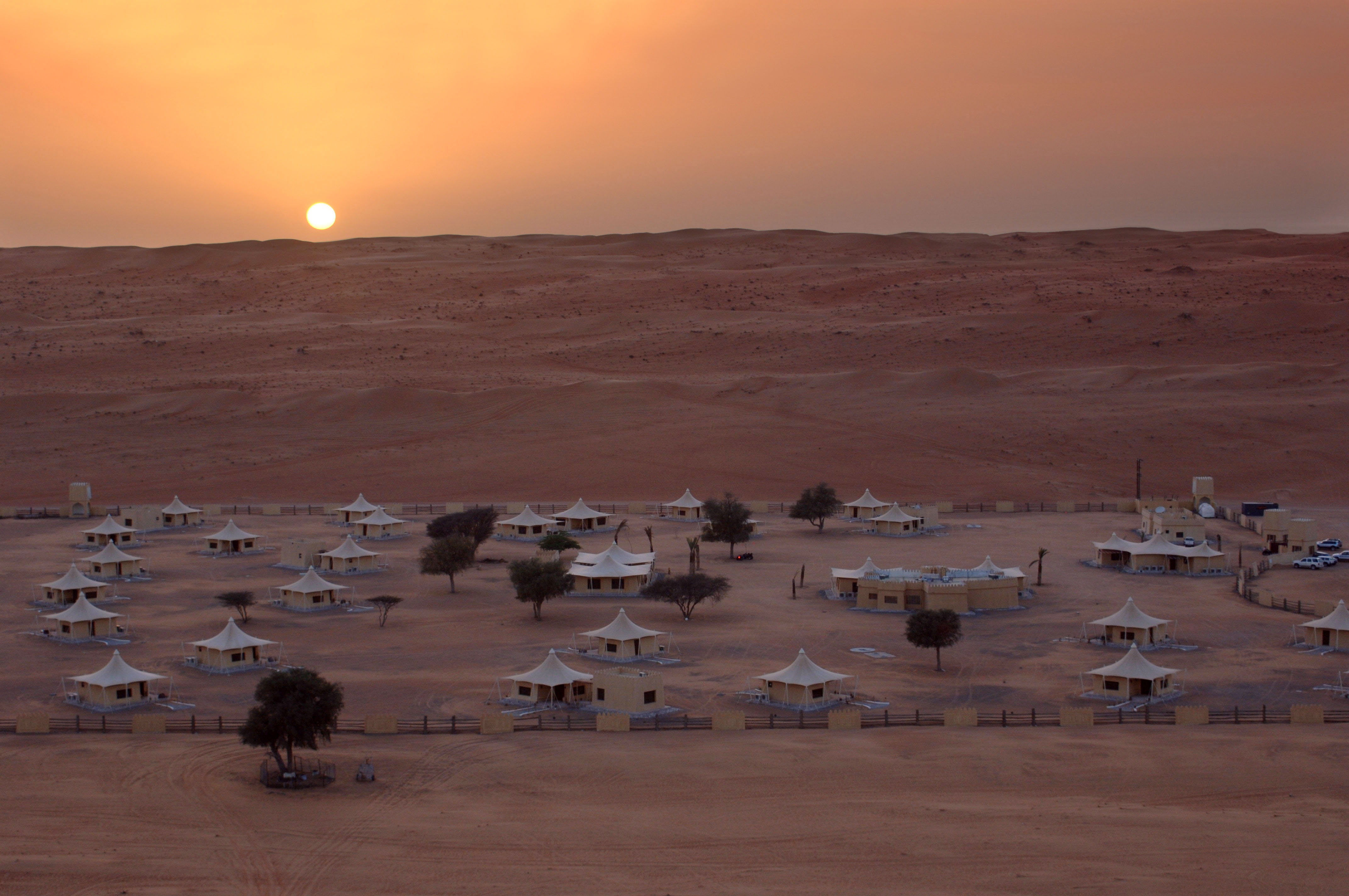The sun rises on the vast desert which plays host to Desert Nights Camp, Oman