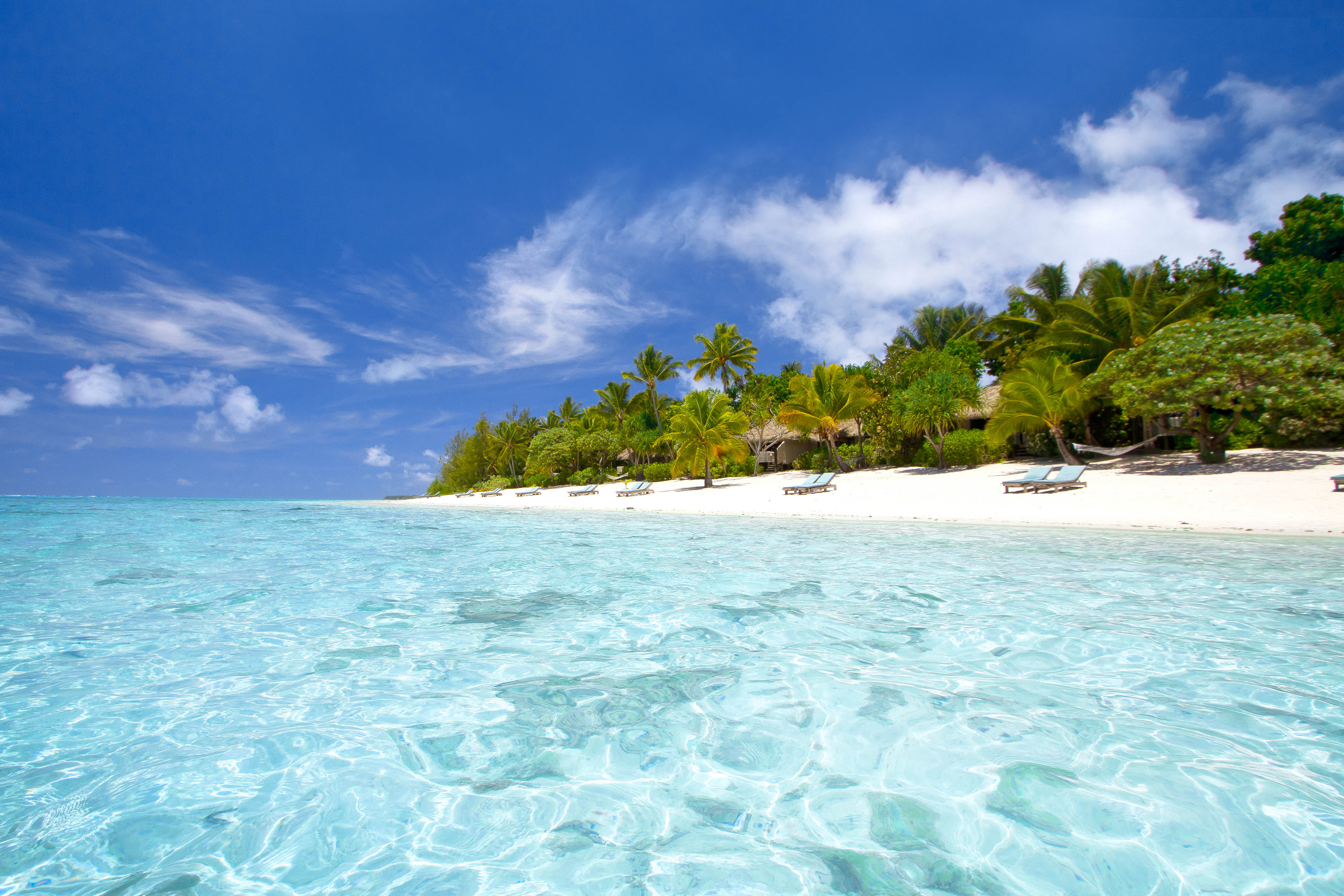 Crystal clear waters and perfect white sand beach at Pacific Resort Aitutaki