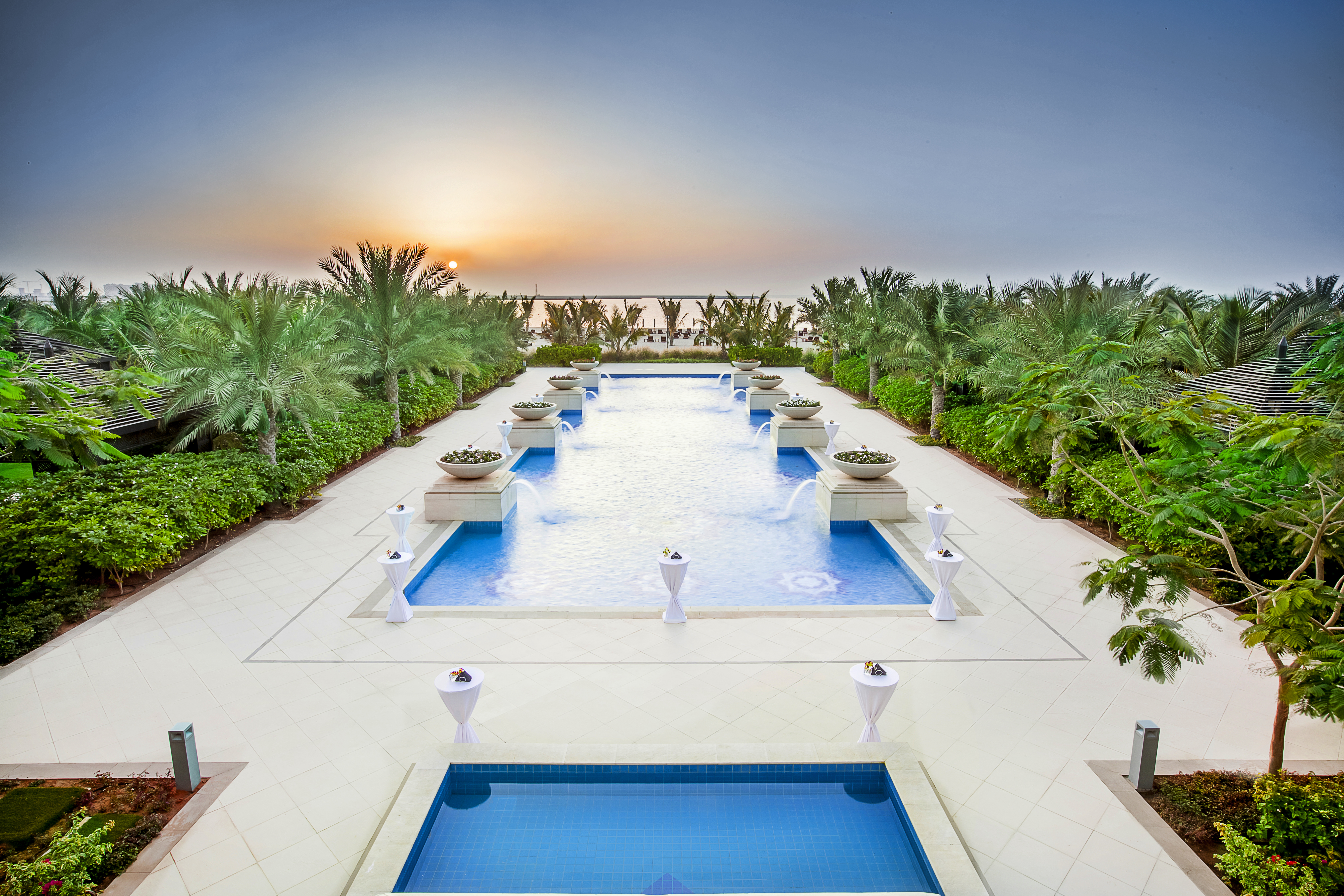 Rich, luscious vegetation skirts this secluded pool looking over sunset at the Waldorf Astoria, Ras Al Khaimah