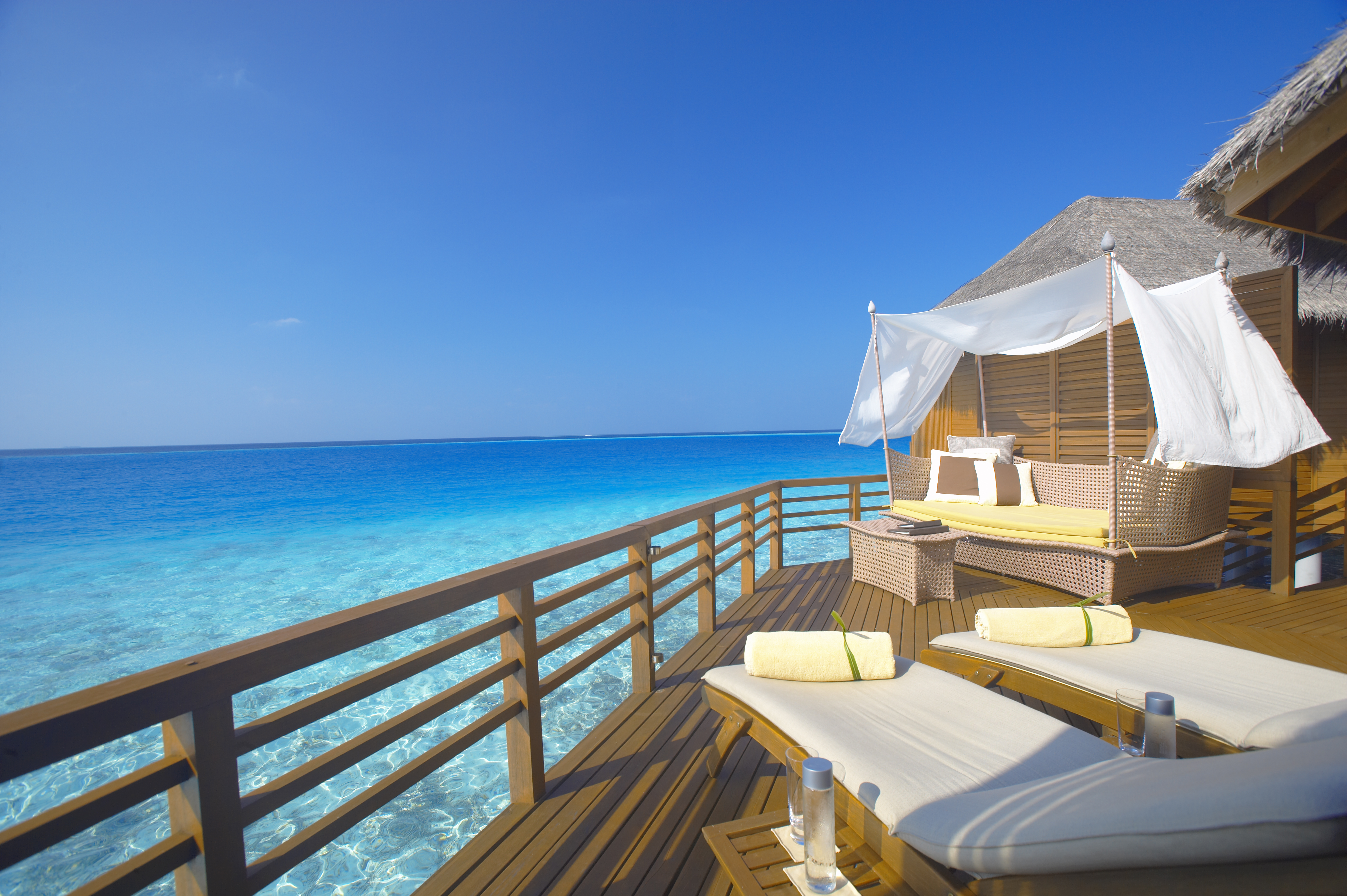 The balcony of a private sea view villa overlooks the impossible blue of the ocean at Baros, the Maldives
