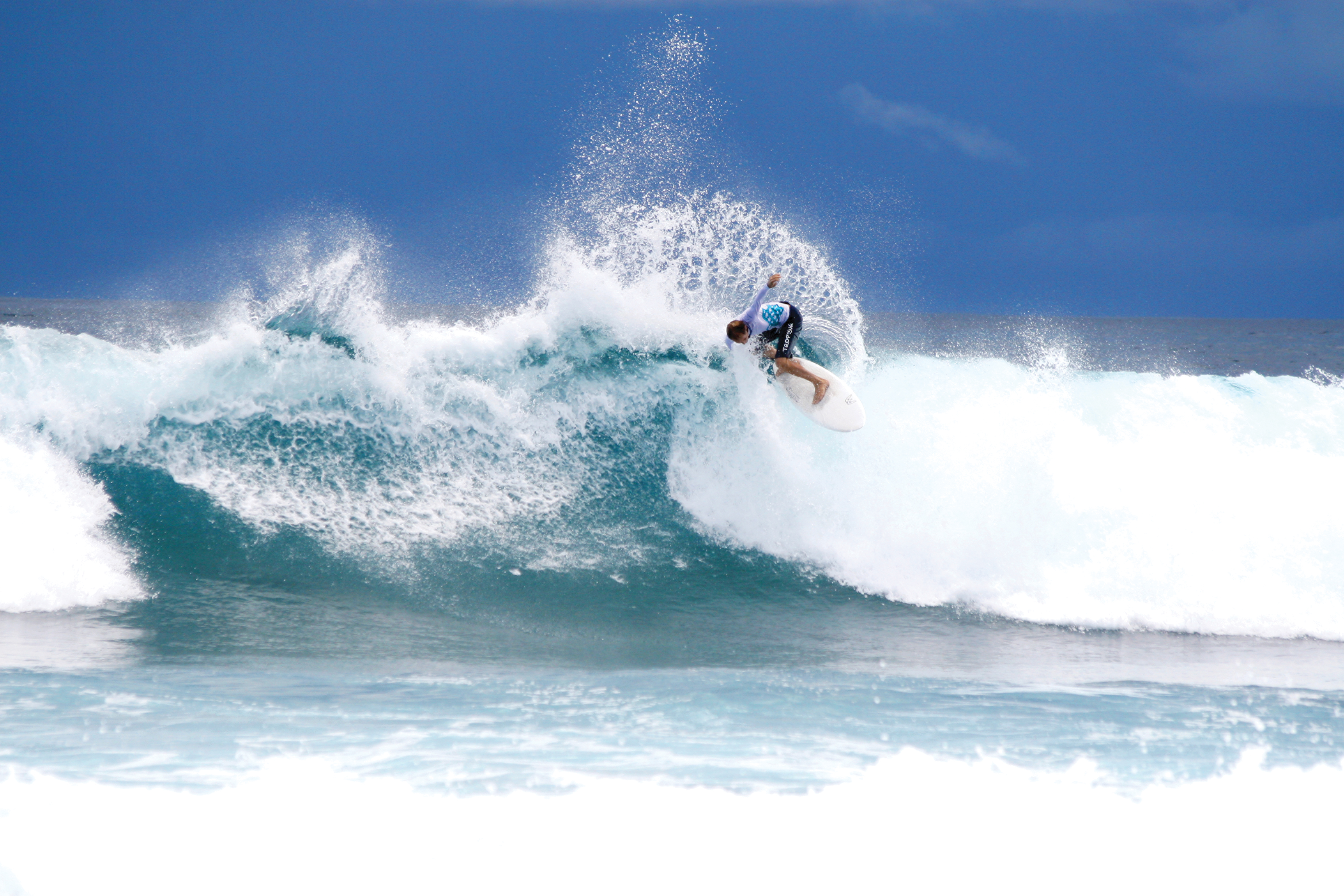 Catching some waves with the surfing on offer at Four Seasons Kuda Huraa Resort, the Maldives