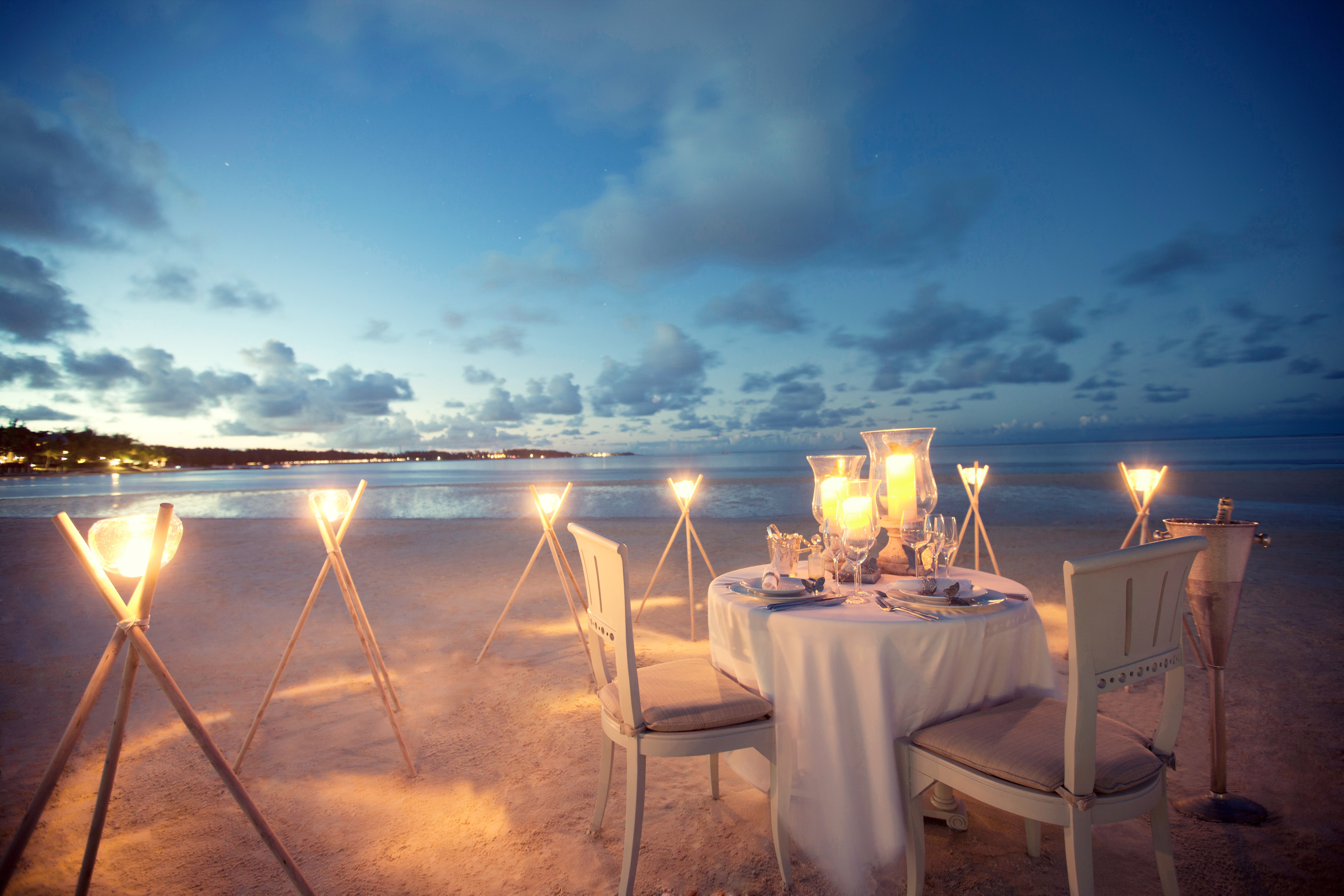 Romantic, intimate, candlelit dining on the beach in the evening at LUX* Belle Mare, Mauritius