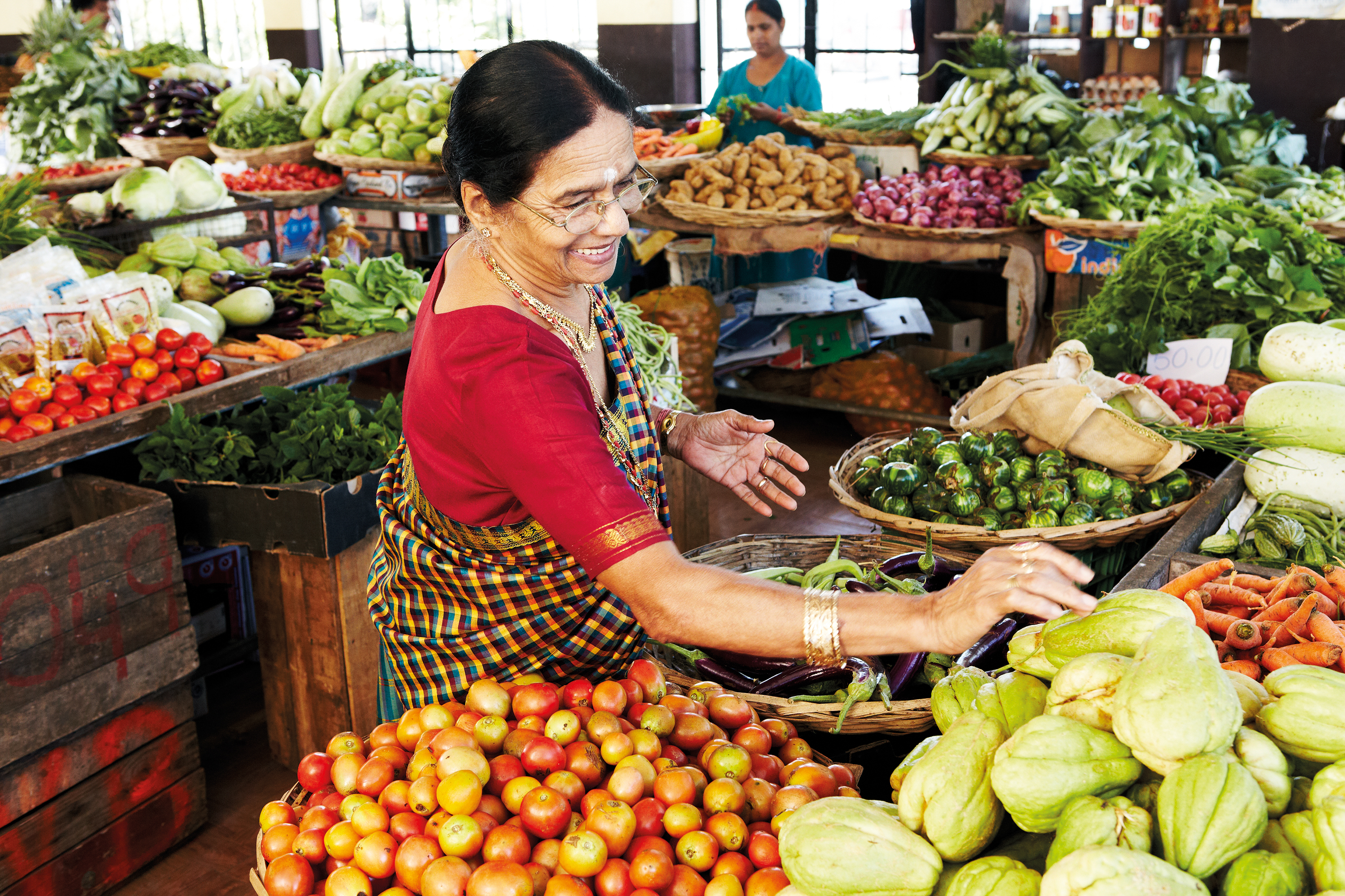 A grandmother purchases some fresh vegetables for cooking at Shanti Maurice Resort and Spa, Mauritius