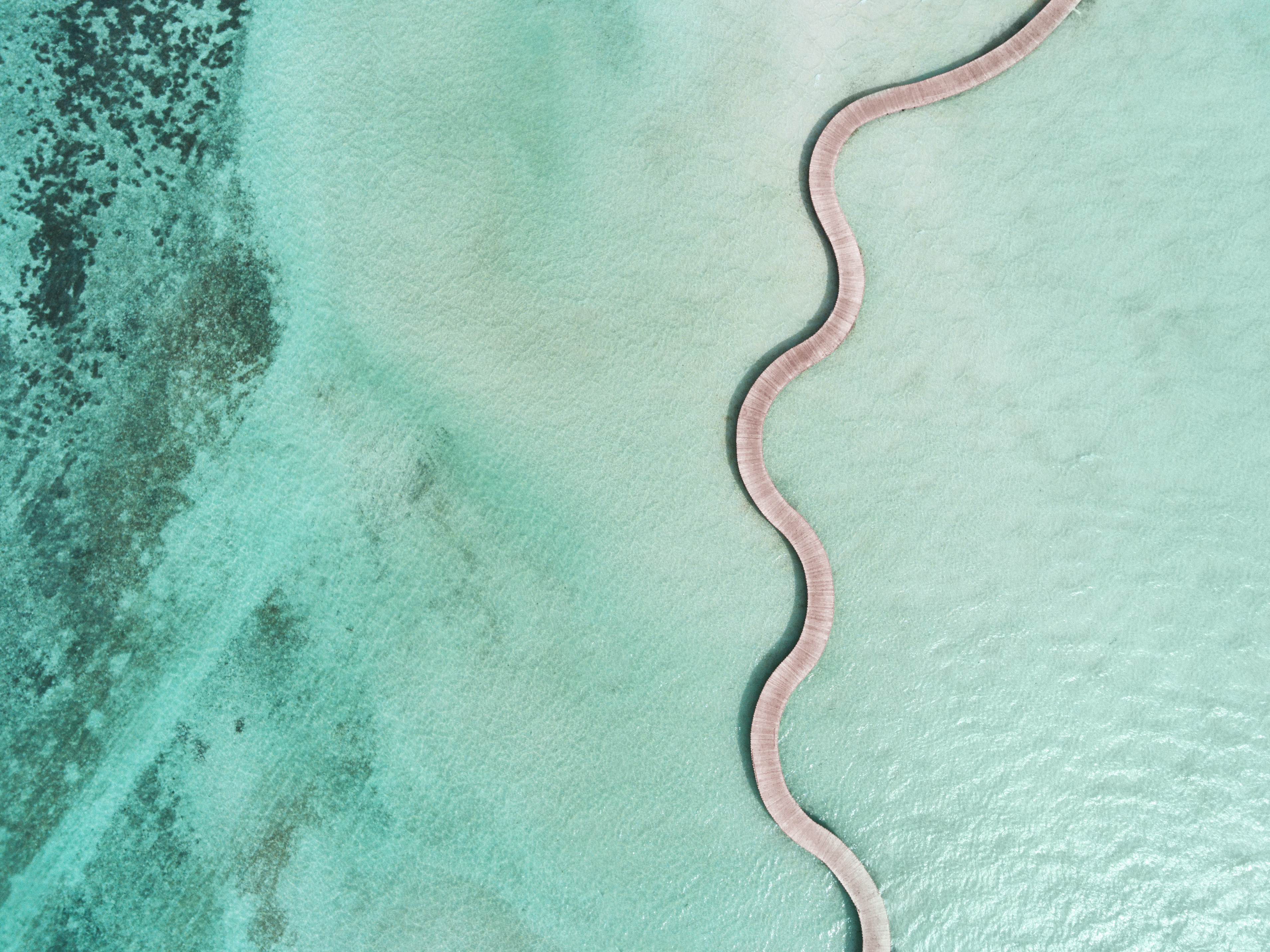 Walkway over the water at Sonvea Jani Resort in the Maldives