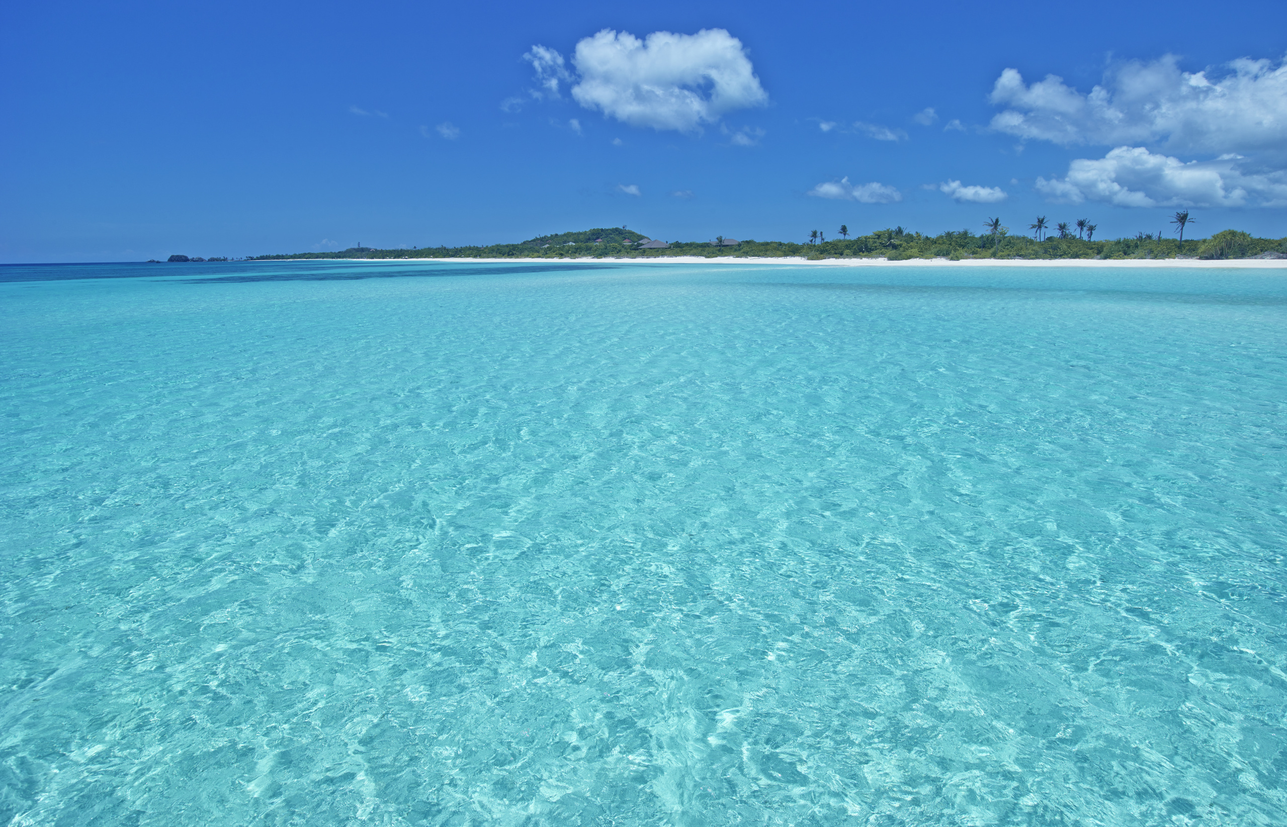 Beach views from the turquoise sea at Amanpulo