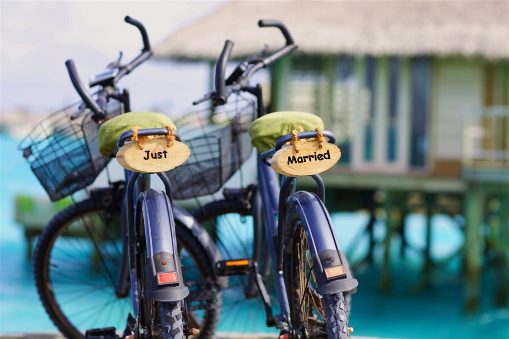 Just married on the back of bikes at Six Senses Laamu
