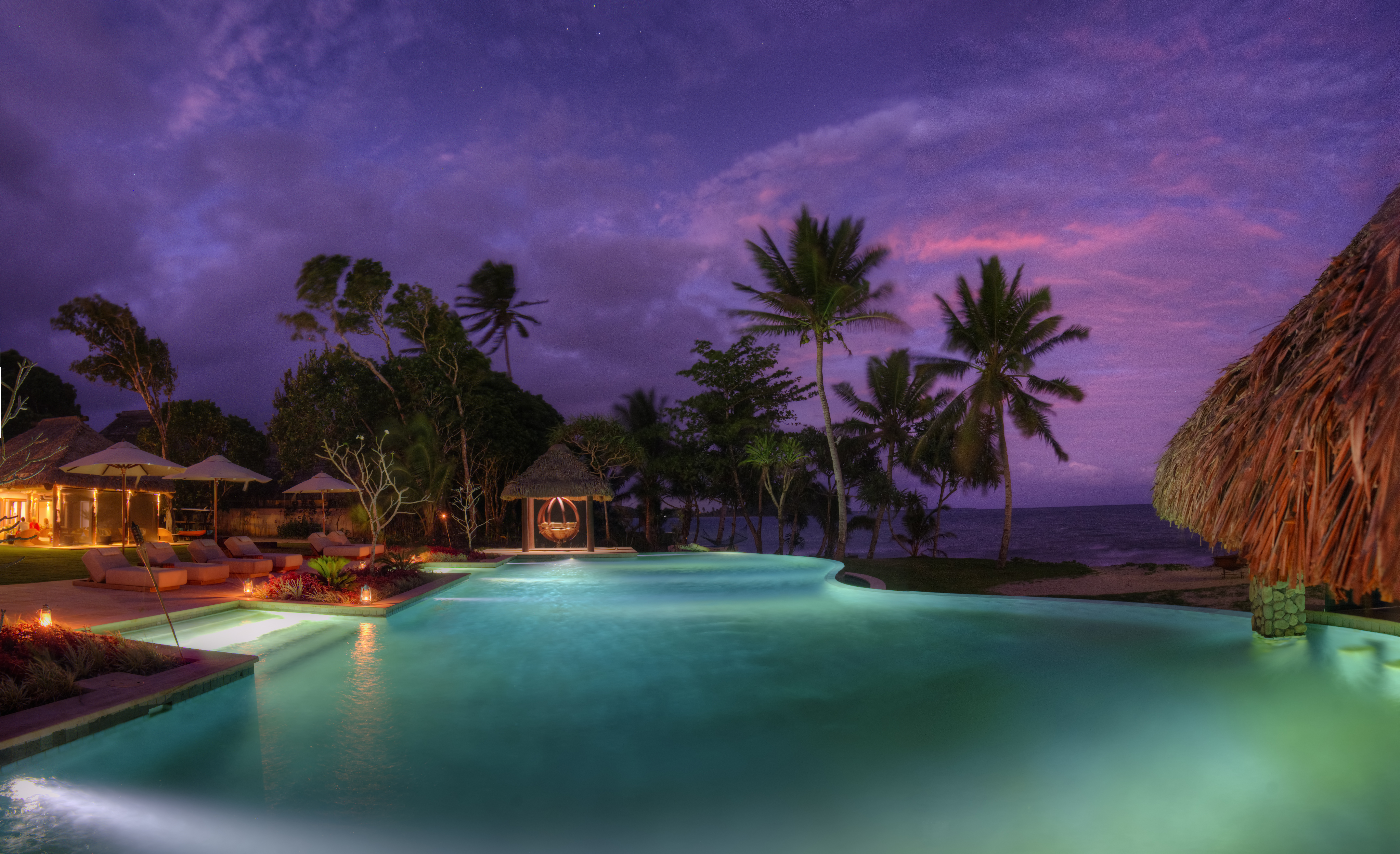 Sunset behind the clubhouse pool at Nanuku